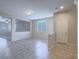 Open-concept living room with tile flooring, a ceiling fan, and views into the adjacent room at 7605 Lake Fork Peak St, Las Vegas, NV 89166