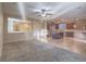 Spacious living room open to kitchen with ceiling fan, tile and carpet flooring at 7605 Lake Fork Peak St, Las Vegas, NV 89166