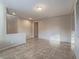 Neutral-painted living room with tile flooring, an inset wall, and ample natural light at 7605 Lake Fork Peak St, Las Vegas, NV 89166
