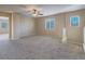 Large loft area with plush carpet, neutral walls, and plenty of natural light at 7605 Lake Fork Peak St, Las Vegas, NV 89166