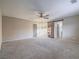 Spacious main bedroom with carpeting and a decorative barn door at 7605 Lake Fork Peak St, Las Vegas, NV 89166