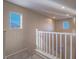 Carpeted staircase with white railing and natural light streaming in at 7605 Lake Fork Peak St, Las Vegas, NV 89166