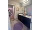 Double sink bathroom with playful decor, featuring a patterned shower curtain at 7636 Bandon Cliffs St, North Las Vegas, NV 89084