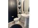 Chic powder room with black accent wall, pedestal sink and updated fixtures at 7636 Bandon Cliffs St, North Las Vegas, NV 89084