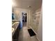 Bathroom featuring granite double vanity, walk-in closet, and glass door shower at 7636 Bandon Cliffs St, North Las Vegas, NV 89084