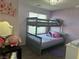 Shot of a bedroom with purple walls, bunkbeds, and princess decorations at 7636 Bandon Cliffs St, North Las Vegas, NV 89084