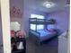 Purple bedroom with bunkbeds, decorated with princess themed accessories at 7636 Bandon Cliffs St, North Las Vegas, NV 89084