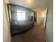 Stylish bedroom with a four-poster bed, a large window, and access to a walk-in closet at 7636 Bandon Cliffs St, North Las Vegas, NV 89084