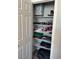 Walk-in closet with open shelving and various items neatly organized at 7636 Bandon Cliffs St, North Las Vegas, NV 89084