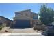 Two-story home featuring a paver driveway, a two-car garage and a modern design at 7636 Bandon Cliffs St, North Las Vegas, NV 89084