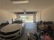 Attached garage with overhead door and car parked inside at 7636 Bandon Cliffs St, North Las Vegas, NV 89084