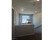Hallway featuring a window, railing, and neutral decor at 7636 Bandon Cliffs St, North Las Vegas, NV 89084
