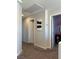 Hallway with gray walls and brown carpet leading to a bedroom at 7636 Bandon Cliffs St, North Las Vegas, NV 89084