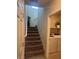 Hallway leading to carpeted stairs and laundry room with modern washer and dryer at 7636 Bandon Cliffs St, North Las Vegas, NV 89084