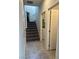 Hallway leading to carpeted stairs and laundry room with washer and dryer at 7636 Bandon Cliffs St, North Las Vegas, NV 89084
