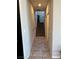 Hallway leading to carpeted stairs with tile floors and access to upstairs at 7636 Bandon Cliffs St, North Las Vegas, NV 89084