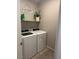 Convenient laundry room featuring modern washer and dryer and shelf at 7636 Bandon Cliffs St, North Las Vegas, NV 89084