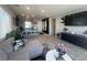 Cozy living area with tile floors and seamless flow to a modern kitchen with bar seating at 7636 Bandon Cliffs St, North Las Vegas, NV 89084