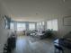 Bright, open-concept living area with tile flooring and lots of natural light from the windows at 7636 Bandon Cliffs St, North Las Vegas, NV 89084