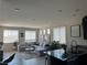 Bright, open-concept living area with tile flooring and lots of natural light from the windows at 7636 Bandon Cliffs St, North Las Vegas, NV 89084