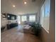 Bright living room featuring neutral color palette, tile floors and large windows at 7636 Bandon Cliffs St, North Las Vegas, NV 89084
