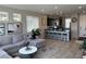 Inviting living area with tile floors, stylish decor, and seamless flow to kitchen with bar seating at 7636 Bandon Cliffs St, North Las Vegas, NV 89084