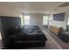 Bright main bedroom featuring a large bed, stylish decor, and large windows for plenty of light at 7636 Bandon Cliffs St, North Las Vegas, NV 89084