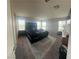 Spacious main bedroom with large windows, a modern bed, and stylish furniture at 7636 Bandon Cliffs St, North Las Vegas, NV 89084