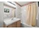 Bright bathroom features a combination tub and shower, along with a vanity at 7950 W Flamingo Rd # 1024, Las Vegas, NV 89147