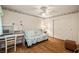 Bedroom offers wood floors, futon, desk, chair, and closet with mirrored doors at 7950 W Flamingo Rd # 1024, Las Vegas, NV 89147