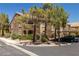 Exterior view of a two-story condo featuring mature landscaping and covered parking at 7950 W Flamingo Rd # 1024, Las Vegas, NV 89147