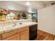 Kitchen sink and breakfast bar overlooking dining area and fireplace at 7950 W Flamingo Rd # 1024, Las Vegas, NV 89147