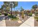 Community pool area with lush landscaping and wrought iron fencing at 7950 W Flamingo Rd # 1024, Las Vegas, NV 89147