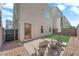 Backyard features a small patch of artificial turf and a stone perimeter at 8072 Haywood Estate, Las Vegas, NV 89113