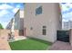 Backyard features a small patch of artificial turf and a stone perimeter at 8072 Haywood Estate, Las Vegas, NV 89113
