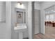 Bathroom featuring a pedestal sink, light walls, and a modern design with a doorway leading to other spaces at 8072 Haywood Estate, Las Vegas, NV 89113