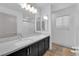 Stylish bathroom featuring a double vanity, large mirror, and a glass-enclosed shower at 8072 Haywood Estate, Las Vegas, NV 89113