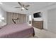 Inviting bedroom with a ceiling fan, dresser, and plush carpeting, illuminated by natural light at 8072 Haywood Estate, Las Vegas, NV 89113