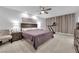 Spacious bedroom with plush carpet, ceiling fan, and a comfortable bed with ample natural light at 8072 Haywood Estate, Las Vegas, NV 89113