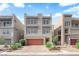 Contemporary three-story home featuring a garage and low-maintenance landscaping at 8072 Haywood Estate, Las Vegas, NV 89113