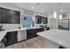 Bright kitchen showcasing dark cabinetry, quartz countertops, stainless steel appliances, and decorative backsplash at 8072 Haywood Estate, Las Vegas, NV 89113