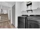 Efficient laundry area with modern appliances and convenient built-in storage cabinets at 8072 Haywood Estate, Las Vegas, NV 89113