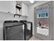Modern laundry room with stainless steel washer and dryer and outdoor access at 8072 Haywood Estate, Las Vegas, NV 89113