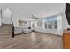 Well-lit living room with staircase, comfortable seating area, and large windows at 8072 Haywood Estate, Las Vegas, NV 89113