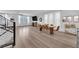 Spacious living room with hardwood floors and lots of natural light, with a dining area and modern staircase at 8072 Haywood Estate, Las Vegas, NV 89113