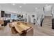 Open-concept living area with modern kitchen, dining space, and staircase at 8072 Haywood Estate, Las Vegas, NV 89113