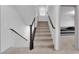 Carpeted staircase with dark wood railing and white walls at 8072 Haywood Estate, Las Vegas, NV 89113