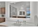 Modern sink with illuminated mirror reflecting a shower and an outdoor view at 818 Calluna St, Las Vegas, NV 89138