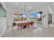 Dining room with modern table and chairs, large windows, and outdoor view at 818 Calluna St, Las Vegas, NV 89138