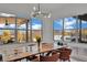 Bright dining room featuring views of the pool through large windows, and a modern light fixture at 818 Calluna St, Las Vegas, NV 89138